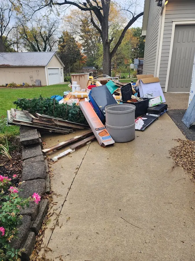 Dumpster being loaded with debris for Estate Cleanout Dumpster Rental in Cedarville